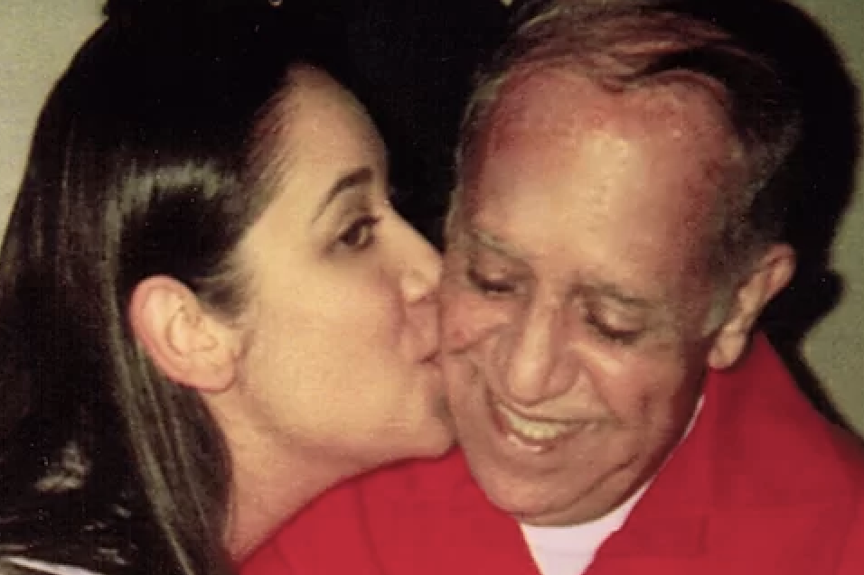 woman kissing her father on the cheek
